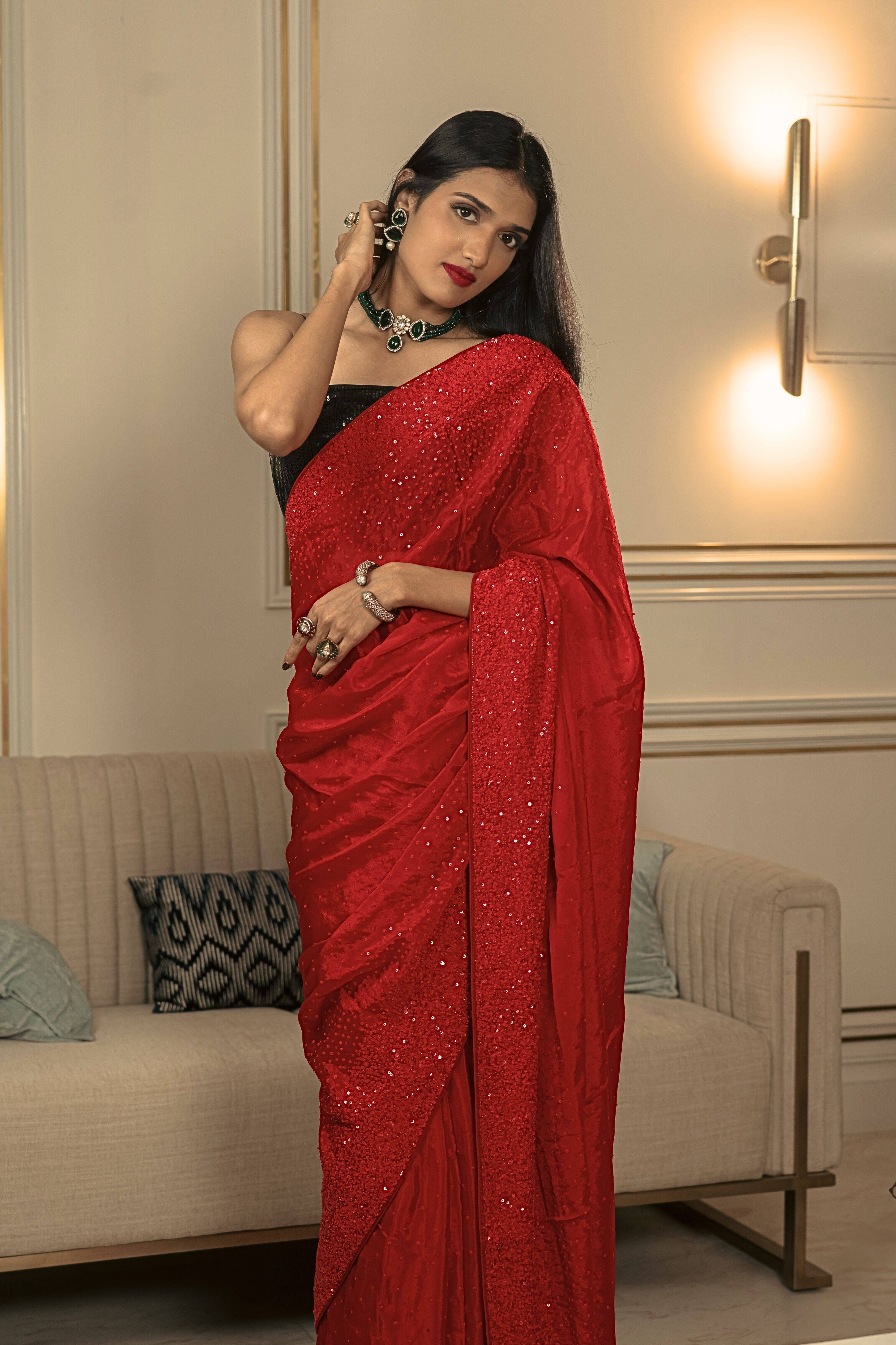 Woman wearing a handcrafted iconic red sequin saree 